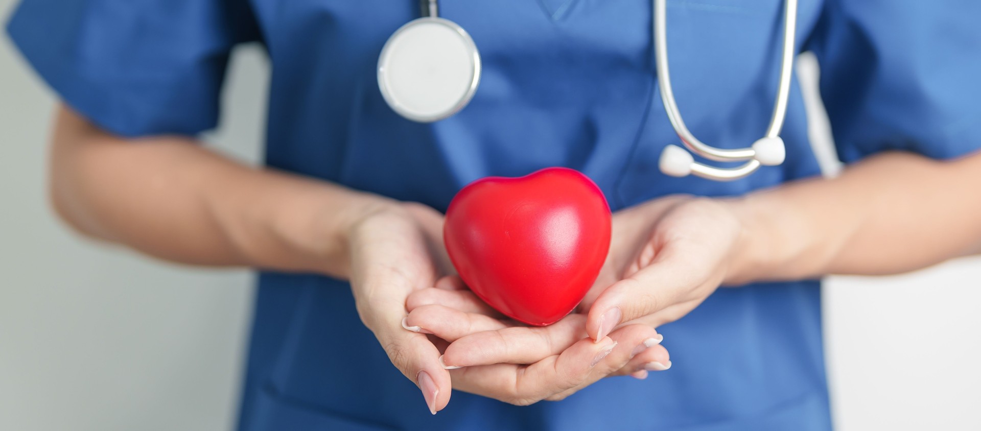 Doctor hand holding red heart shape in hospital. love, donor, world heart day, world health day, CSR donation and Insurance concepts